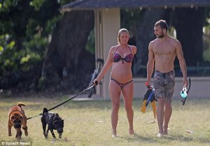 Inspirational: She showed off her enormous baby bump in a multi-colored bikini and a pretty gold necklace