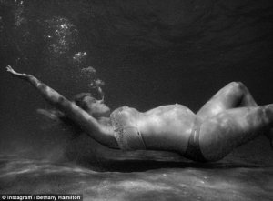 'Mermaid momma': Bethany became an inspiration worldwide aged 13 when she climbed back on her surfboard after the brutal 2003 shark attack. Above, she is pictured lying down underwater in another Instagram shot